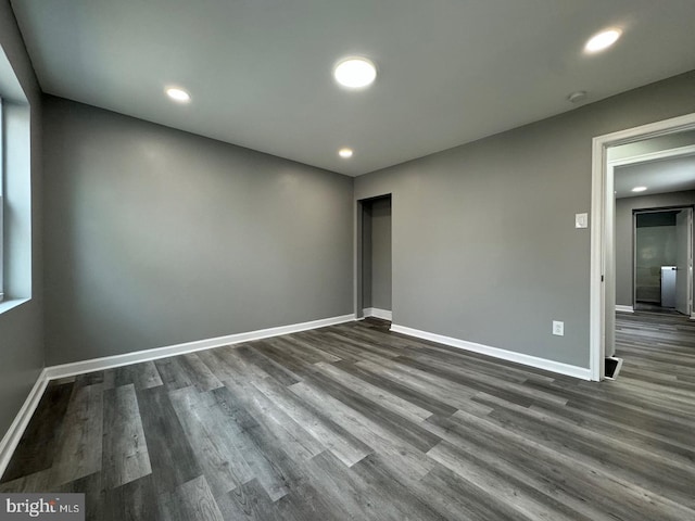 spare room with dark wood-type flooring