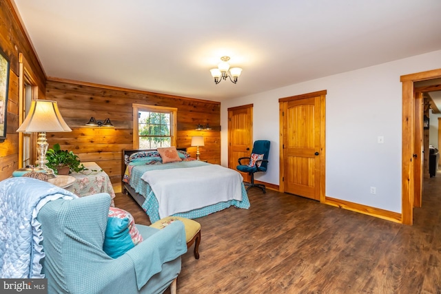 bedroom featuring a notable chandelier, dark hardwood / wood-style flooring, and wooden walls