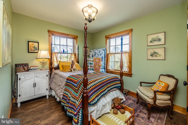 bedroom with dark hardwood / wood-style flooring