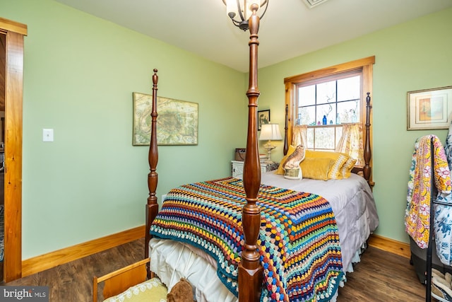 bedroom with dark hardwood / wood-style flooring