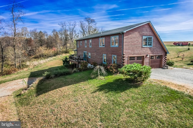 view of property exterior with a yard and a garage