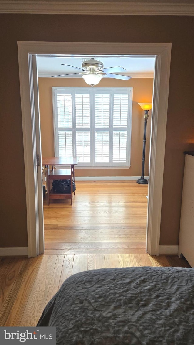 bedroom featuring light wood-type flooring and ornamental molding