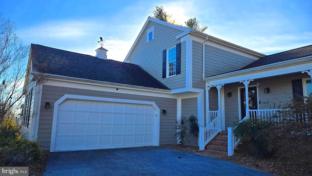 view of front of home with a porch and a garage