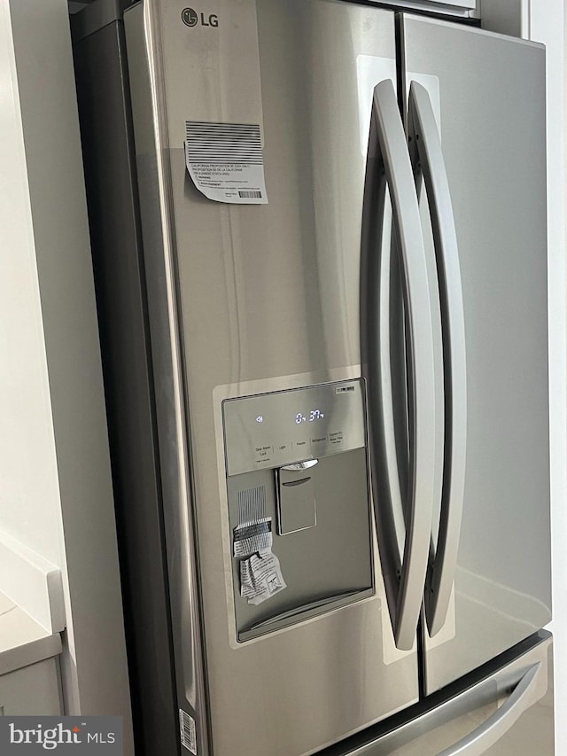 room details with stainless steel fridge with ice dispenser