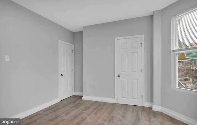 unfurnished bedroom featuring light wood-type flooring