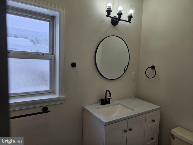 bathroom featuring toilet and vanity