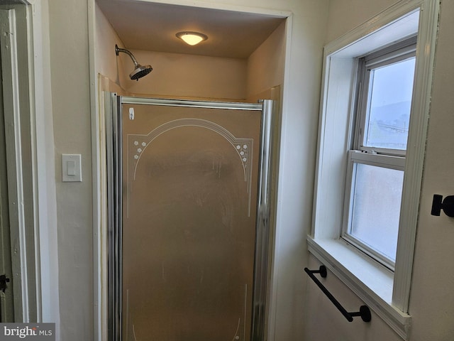 bathroom with a shower with shower door