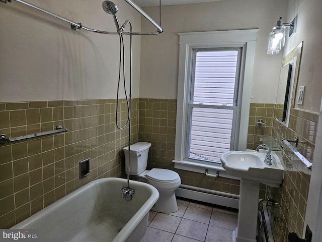 bathroom with toilet, tile walls, tile patterned floors, a baseboard radiator, and sink