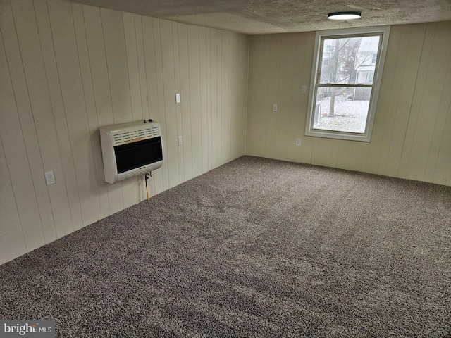 interior space with wood walls and heating unit