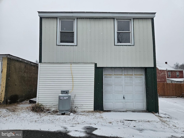 snow covered house with a garage