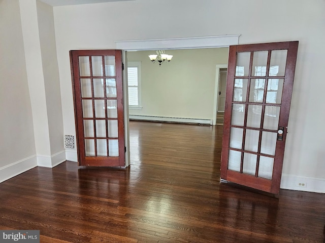 empty room with dark wood-type flooring, french doors, an inviting chandelier, and a baseboard radiator