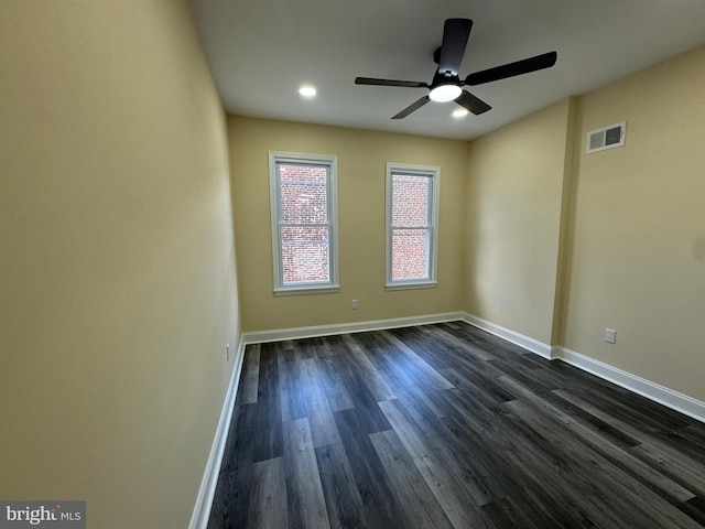 spare room with ceiling fan and dark hardwood / wood-style floors