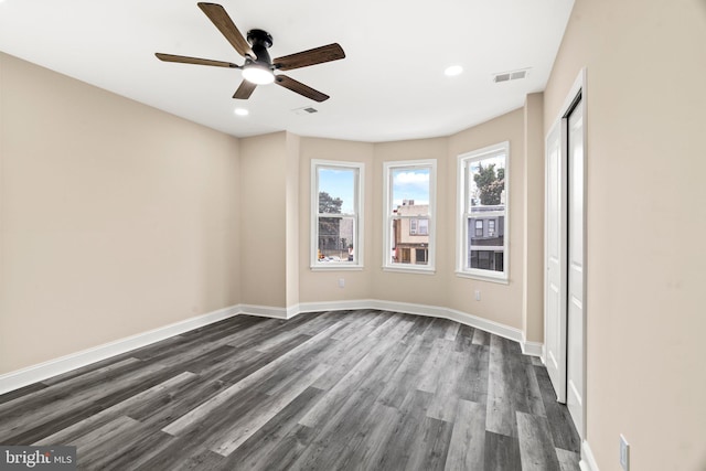 unfurnished room with ceiling fan and dark hardwood / wood-style flooring