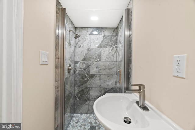 bathroom featuring sink and a shower with door