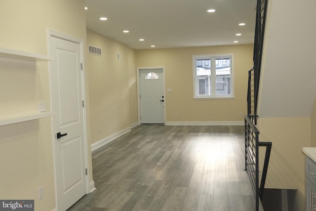 entryway with dark hardwood / wood-style flooring