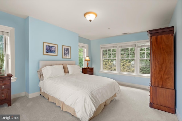 bedroom featuring light colored carpet