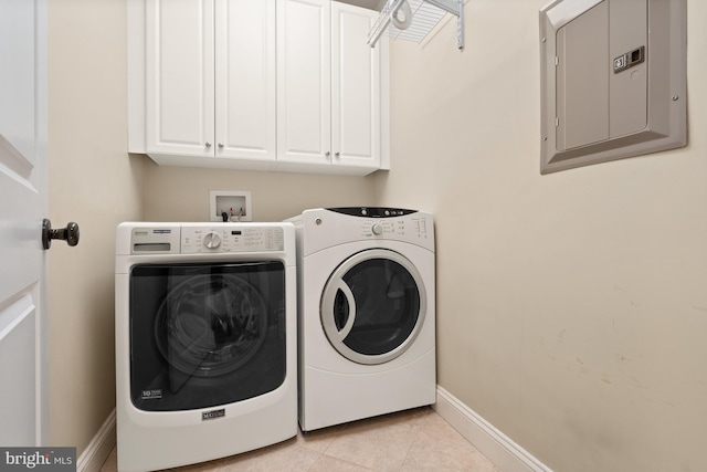 clothes washing area featuring washer and dryer, light tile patterned flooring, cabinets, and electric panel