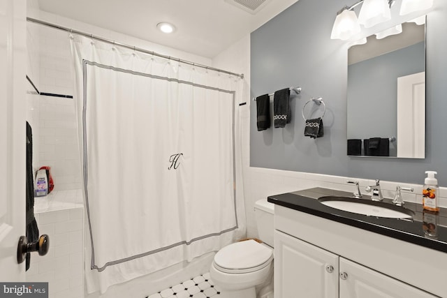 full bathroom featuring tile patterned floors, vanity, toilet, and shower / tub combo