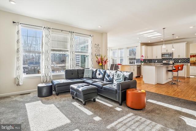 living room featuring a healthy amount of sunlight and light colored carpet