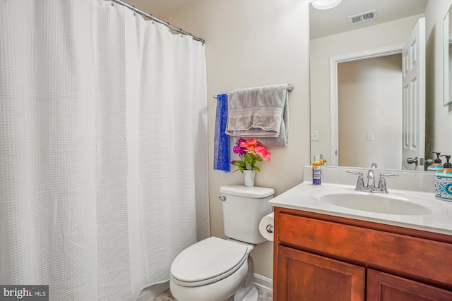 bathroom featuring toilet and vanity