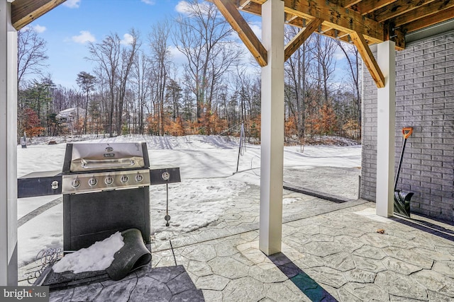 snow covered patio featuring area for grilling