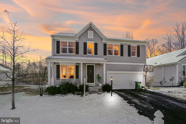 front facade featuring a porch and a garage