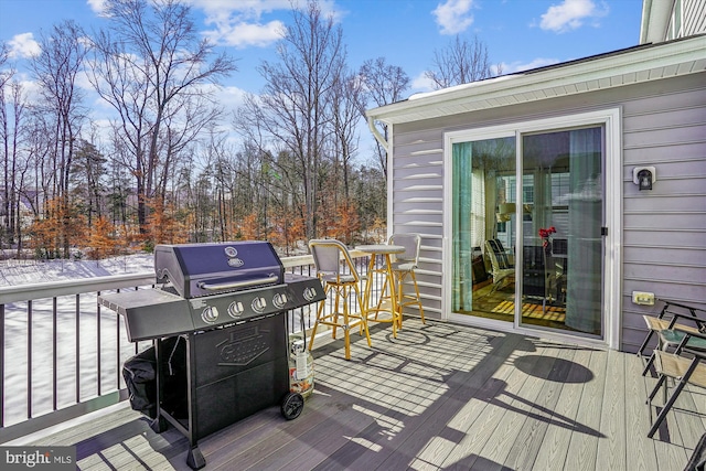 wooden terrace with a grill