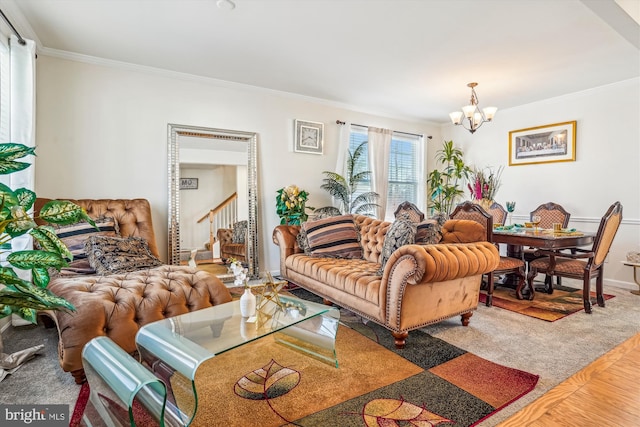 living room with an inviting chandelier and crown molding