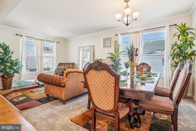 carpeted dining space with an inviting chandelier, a healthy amount of sunlight, and crown molding