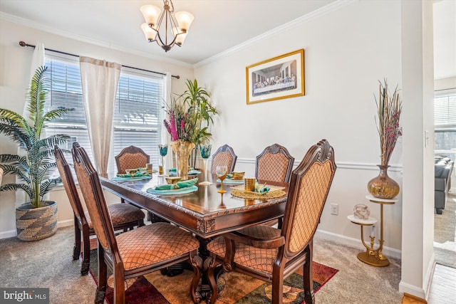 carpeted dining area with a healthy amount of sunlight, crown molding, and a chandelier