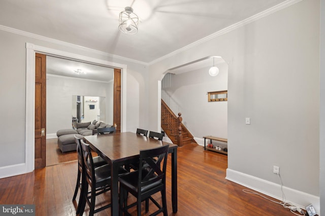 dining area featuring crown molding and dark wood-type flooring