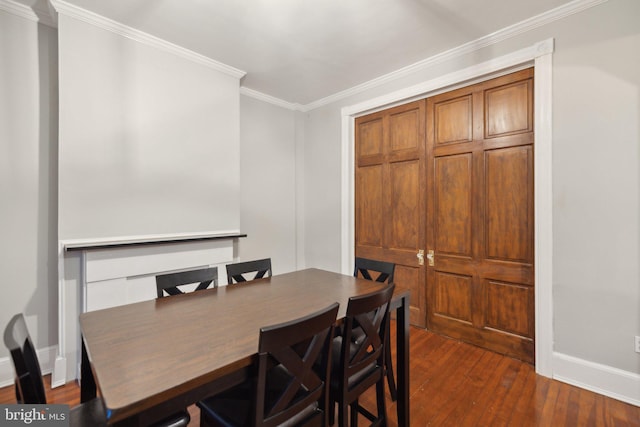 dining area featuring dark hardwood / wood-style floors and ornamental molding