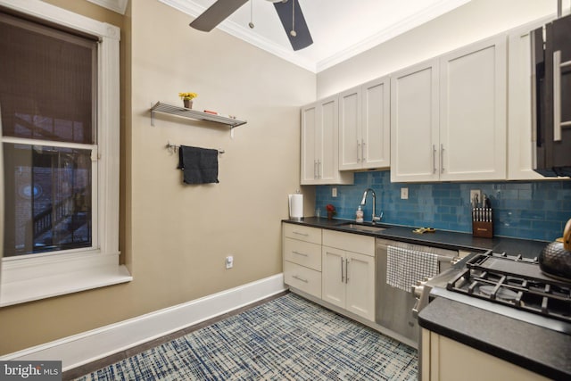 kitchen featuring tasteful backsplash, ceiling fan, crown molding, sink, and white cabinets