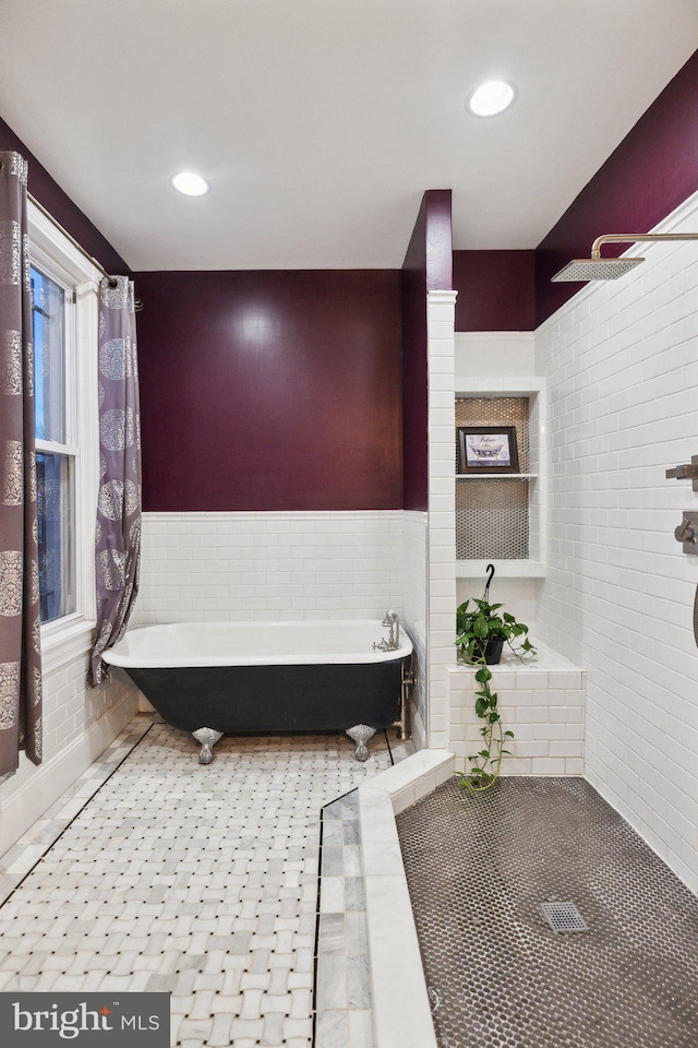 bathroom featuring tile patterned floors, shower with separate bathtub, and tile walls