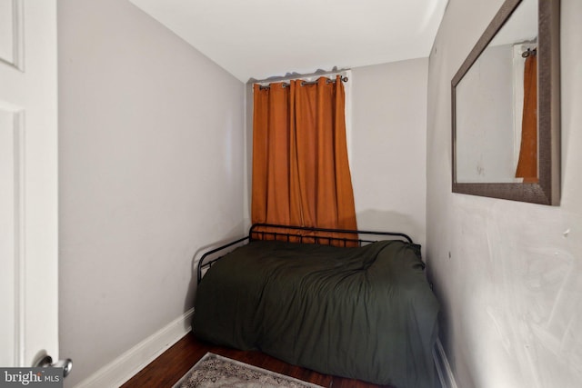 bedroom with dark wood-type flooring