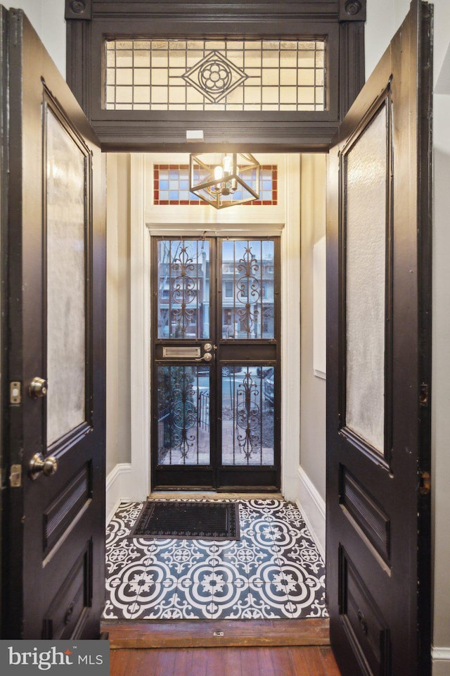 foyer entrance featuring a chandelier, wood-type flooring, and french doors