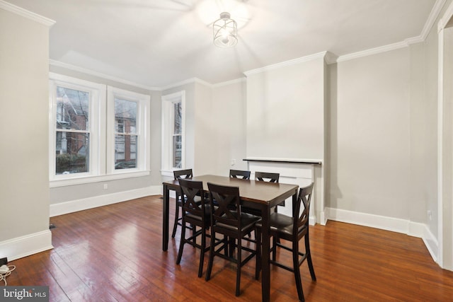 dining space featuring dark hardwood / wood-style floors and ornamental molding