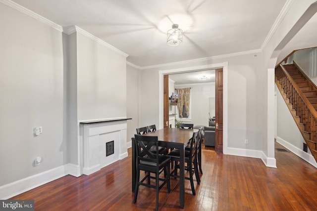 dining area with dark hardwood / wood-style floors and crown molding