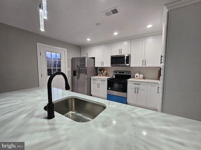 kitchen featuring white cabinetry, sink, and appliances with stainless steel finishes