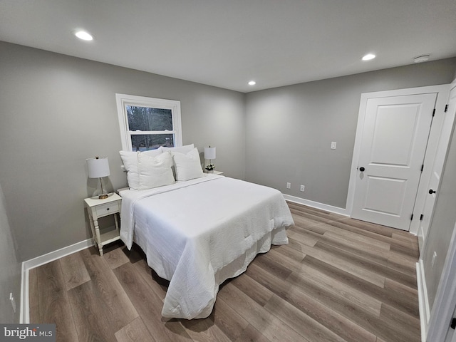 bedroom with hardwood / wood-style flooring