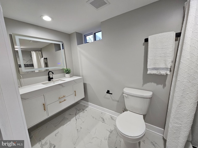 bathroom with vanity and toilet