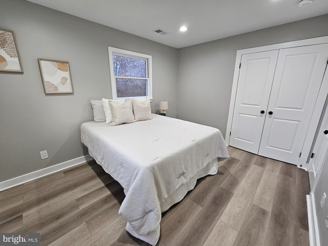 bedroom featuring wood-type flooring and a closet