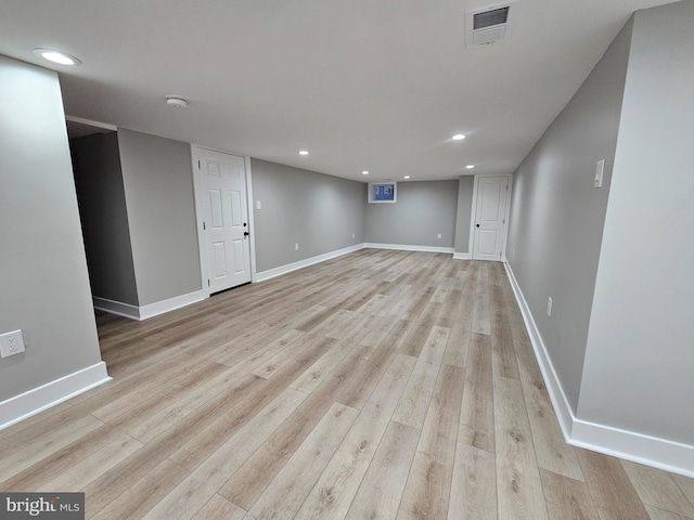 basement with light hardwood / wood-style flooring