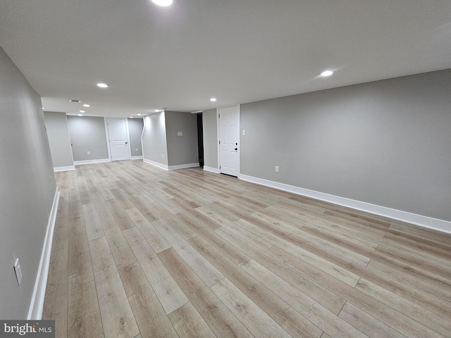 basement with light hardwood / wood-style floors