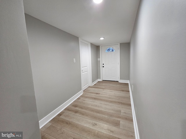 doorway to outside with light wood-type flooring