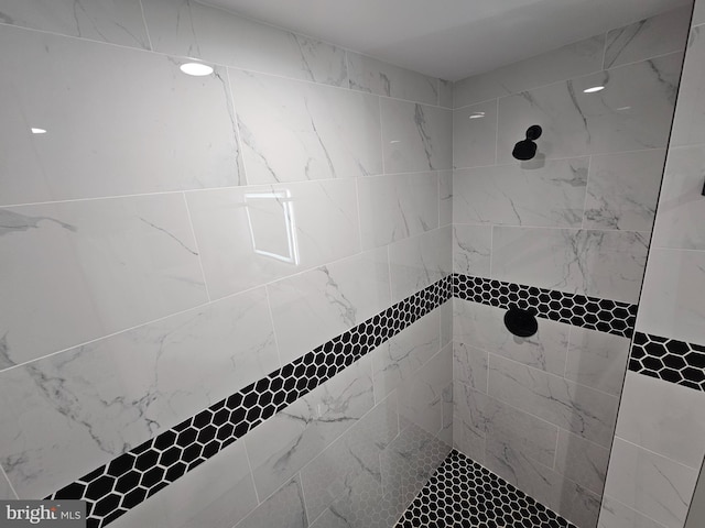 bathroom with a tile shower