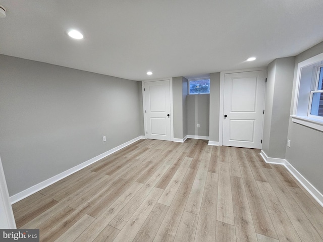 basement with light hardwood / wood-style floors