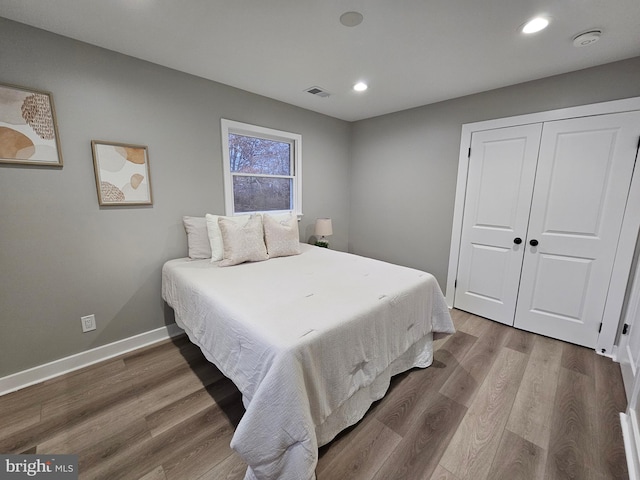 bedroom featuring wood-type flooring and a closet