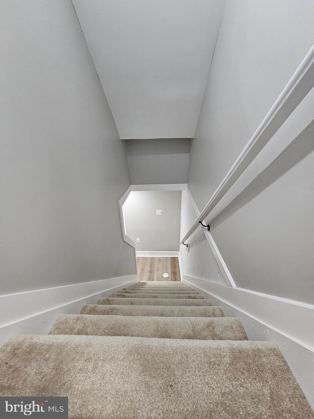 stairs featuring hardwood / wood-style flooring