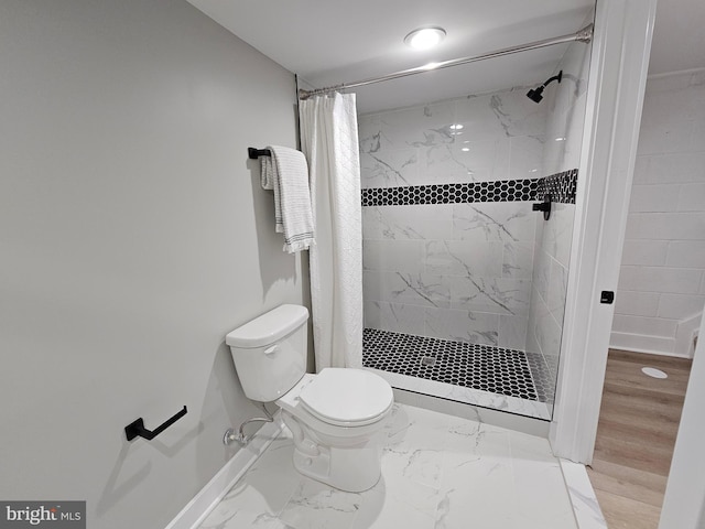 bathroom with curtained shower and toilet